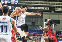 Converge FiberXers’ Bryan Santos grabs the rebound as San Miguel Beermen’s Jaymar Perez looks on. PBA PHOTO