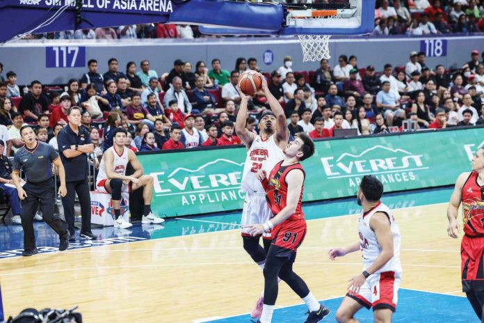 Barangay Ginebra San Miguel Kings’ Raymond Aguilar scores against the defense of San Miguel Beermen's Rodney Brondial. PBA PHOTO
