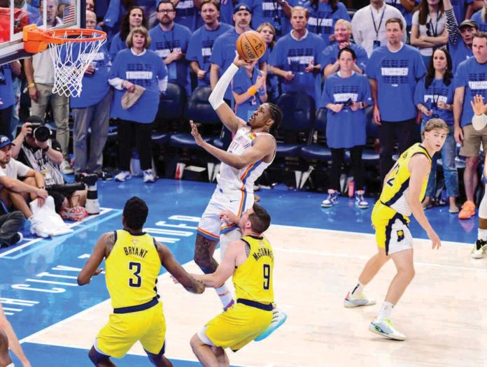 sports_OKC_copy_resized Oklahoma City Thunder’s Jalen Williams soars for an inside basket against the defense of Indiana Pacers’ Thomas Bryant and TJ McConnell. GETTY IMAGES