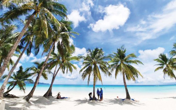 tourism-share Tourists rest under the shade of coconut trees in the world famous Boracay Island in this undated photo. The tourism sector contributed about 8.9 percent to the domestic economy’s output in 2024, up from 8.7 percent in the previous year, the Philippine Statistics Authority reported on June 19, 2025. PNA FILE PHOTO BY JOYCE ROCAMORA