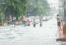 Residents of Barangay Frances, Calumpit, Bulacan wade through knee-deep floodwaters caused by the southwest monsoon (habagat). The town is under a state of calamity. PNA