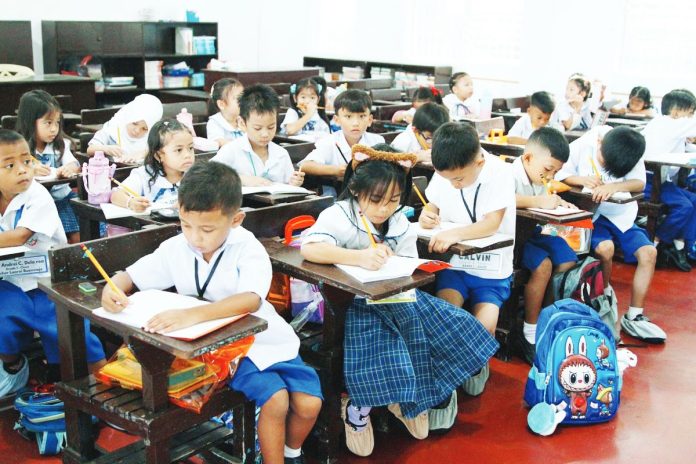 Students begin writing on their new notebook during the first day of school for Academic Year 2025-2026 at Santiago Elementary School in Barangay Santiago, City of General Trias, Cavite on June 16, 2025. Some 27 million students nationwide have returned to their classes. PNA