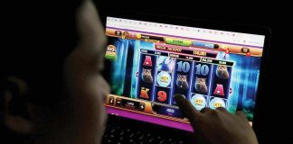 A teen in Manila plays an online casino game accessed through a laptop. A bill has been filed in the Senate seeking an outright ban on online gambling in the country. Another bill bars the use of e-wallets in online betting. MARIANNE BERMUDEZ, PHILIPPINE DAILY INQUIRER