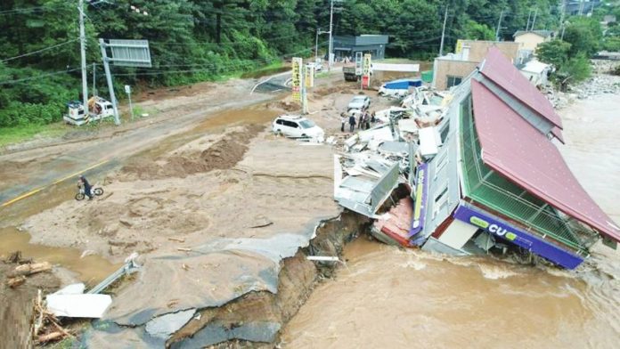 SoKor copy Strong floodwaters swept through southeastern South Korea on Sunday. BBC