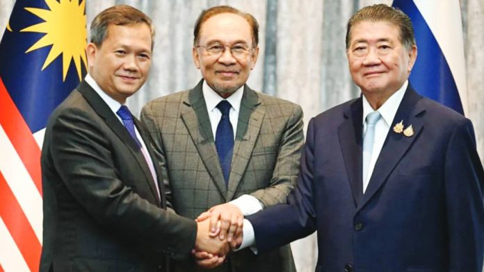 Thailand Malaysia's Prime Minister Anwar Ibrahim (center), Cambodia's Prime Minister Hun Manet (left) and Thailand's acting Prime Minister Phumtham Wechayachai pose for photos as they shake hands. GETTY IMAGES