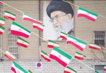 A mural of Iran’s Supreme Leader Ayatollah Ali Khamenei is seen on the side of a building in Azadi avenue with reams of Iranian national flags hanging in the foreground, in Tehran. GETTY IMAGES