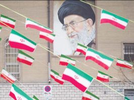 A mural of Iran’s Supreme Leader Ayatollah Ali Khamenei is seen on the side of a building in Azadi avenue with reams of Iranian national flags hanging in the foreground, in Tehran. GETTY IMAGES