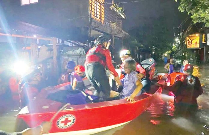 bacolod_floods_copy_resized Personnel of the Philippine Red Cross Negros Occidental-Bacolod City Chapter’s Emergency Response Unit conduct rescue operation in Purok Isla, Barangay Villamonte, Bacolod City after residents experienced flooding, on Friday night, July 11, 2025. Philippine Red Cross NegOcc-Bacolod City Chapter PHOTO