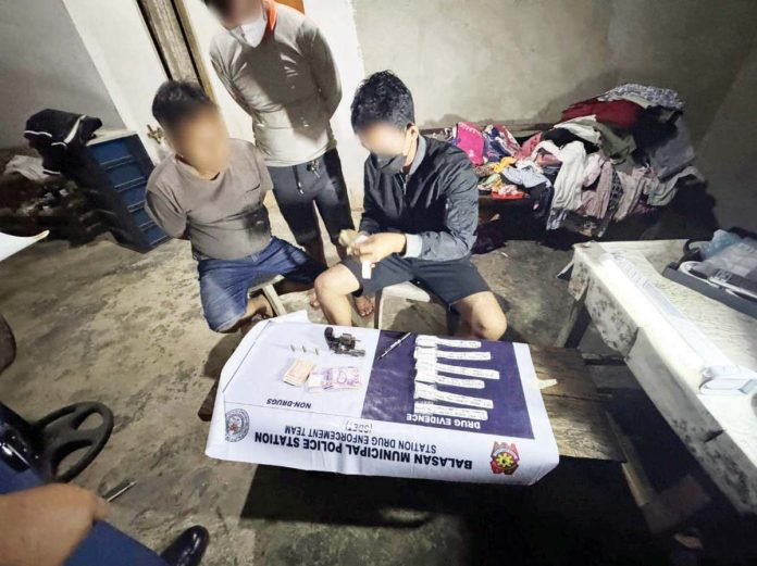 balasan_drug_sting_resized Officers of the Balasan Municipal Police Station apprehended alias “Putot” (left) in a drug buy-bust operation in Barangay Salong, Balasan, Iloilo on Monday night, July 14, 2025. IPPO PHOTO