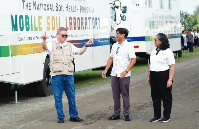 President Ferdinand “Bongbong” Marcos Jr. (center) turns over one of the mobile soil laboratories to the Department of Agriculture – Western Visayas, represented by Regional Executive Director Dennis Arpia (left), during a ceremonial distribution in Nueva Ecija province. The mobile labs are part of the National Soil Health Program to help farmers improve productivity through science-based soil analysis. Photo from Department of Agriculture Facebook Page