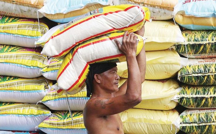 imported-rice A worker loads a sack of rice in Manila as the Department of Agriculture announces a reduction in the maximum suggested retail price for imported rice to P43 per kilogram starting July 16, 2025. INQUIRER PHOTO / NINO JESUS ORBETA