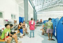 Evacuees settle in a temporary shelter set up inside a covered gymnasium in Iloilo City after successive storms and monsoon rains displaced nearly 57,000 residents. AJ PALCULLO/PN
