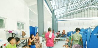 Evacuees settle in a temporary shelter set up inside a covered gymnasium in Iloilo City after successive storms and monsoon rains displaced nearly 57,000 residents. AJ PALCULLO/PN