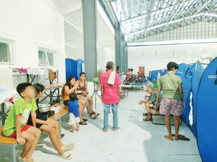 mai gaps Evacuees settle in a temporary shelter set up inside a covered gymnasium in Iloilo City after successive storms and monsoon rains displaced nearly 57,000 residents. AJ PALCULLO/PN