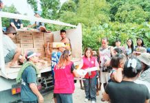 Department of Social Welfare and Development personnel distribute family food packs to residents of Barangay Alopijan, Culasi, Antique on July 23, following the onslaught of heavy rains brought by the enhanced southwest monsoon (habagat) intensified by recent tropical cyclones. DSWD PHOTO