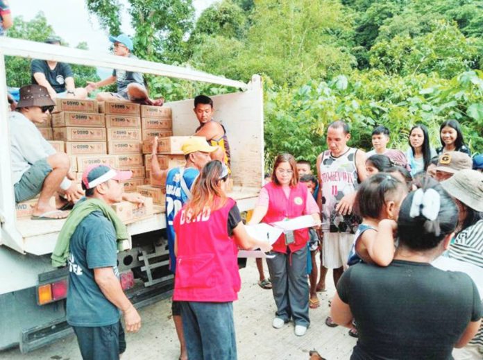 Department of Social Welfare and Development personnel distribute family food packs to residents of Barangay Alopijan, Culasi, Antique on July 23, following the onslaught of heavy rains brought by the enhanced southwest monsoon (habagat) intensified by recent tropical cyclones. DSWD PHOTO