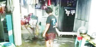 A resident wades through floodwaters inside her home in Iloilo City — a high-risk exposure that health officials warn could lead to leptospirosis if preventive medication is not taken promptly. ILOILO CITY DRRMO PHOTO