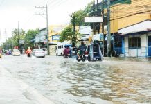 Vehicles navigate a flooded street in Iloilo City following days of heavy rains brought by successive storms and the southwest monsoon. The city has since declared a state of calamity to fast-track relief and recovery efforts. AJ PALCULLO/PN