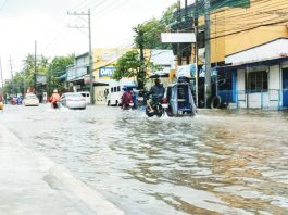 Vehicles navigate a flooded street in Iloilo City following days of heavy rains brought by successive storms and the southwest monsoon. The city has since declared a state of calamity to fast-track relief and recovery efforts. AJ PALCULLO/PN