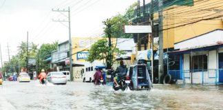 Vehicles navigate a flooded street in Iloilo City following days of heavy rains brought by successive storms and the southwest monsoon. The city has since declared a state of calamity to fast-track relief and recovery efforts. AJ PALCULLO/PN