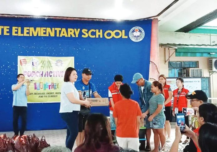 Mayor Raisa Treñas leads the distribution of relief goods to families evacuated due to torrential rains and flooding over the weekend at a designated evacuation center in Iloilo City. Data from the City Social Welfare and Development Office showed 34 impacted barangays, with Jaro district bearing the brunt at 17 affected villages, followed by Mandurriao district with eight barangays.