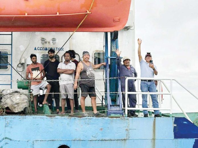 mai_rescue Filipino and Indian crew members of MV Hirman Star wave from the deck of their problematic vessel. They were rescued following weeks of being stuck off Loboc Port, Iloilo City due to the vessel’s unseaworthy condition and unresolved violations. PHOTO BY CONG. JULIENNE BARONDA