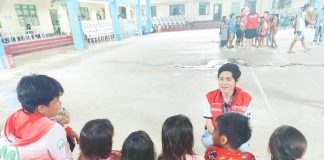 A Department of Social Welfare and Development staff member engages children in a psychosocial support session at an evacuation center in Iloilo City, helping young evacuees process their experiences after being displaced by Tropical Storm Crising and monsoon flooding. PHOTO BY DSWD WESTERN VISAYAS