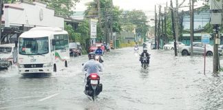 FLOODED COMMUTE. Motorists navigate floodwaters along a portion of La Paz Plaza in Iloilo City on Wednesday, July 23, as continuous rains from the intensified habagat and twin tropical cyclones triggered a Red Alert status. Authorities ordered evacuations in flood- and storm surge-prone areas. AJ PALCULLO/PN