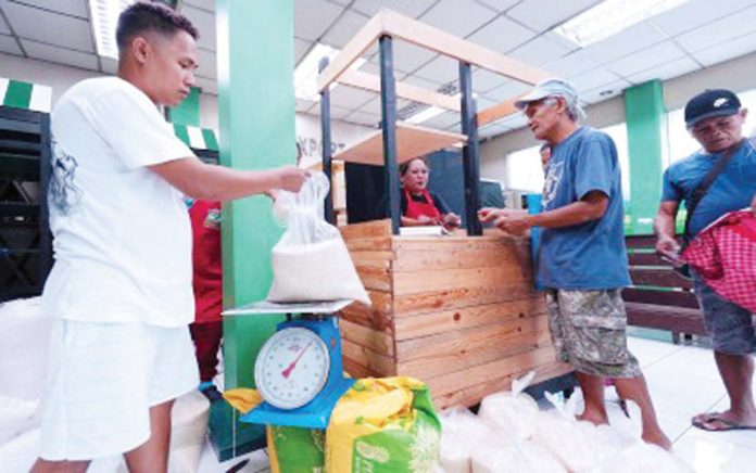 A worker repacks a bag of rice at a Kadiwa ng Pangulo store along Elliptical Road in Diliman, Quezon City on June 4, 2025. Affordable rice is reaching low-income families and overseas Filipino workers while boosting demand for locally-produced rice and dairy. PNA PHOTO BY BEN BRIONES