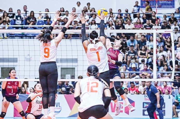 sports-Foxies-copy Farm Fresh Foxies’ Alohi Robins-Hardy tries to block the attack of Desiree Cheng of Choco Mucho Flying Titans. PVL PHOTO