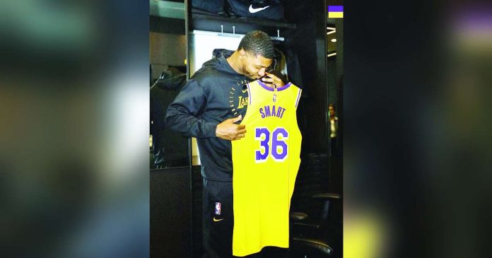 sports Marcus_superimposed Marcus Smart happily looks at his Los Angeles Lakers’ jersey. PHOTO COURTESY OF LA LAKERS