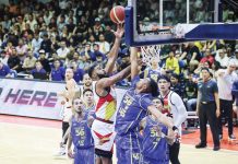 San Miguel Beermen’s Moala Tautuaa scores against the defense of TNT Tropang 5G’s Brandon Ganuelas-Rosser. PBA PHOTO