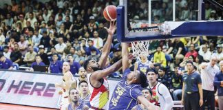 San Miguel Beermen’s Moala Tautuaa scores against the defense of TNT Tropang 5G’s Brandon Ganuelas-Rosser. PBA PHOTO