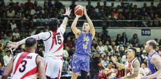 TNT Tropang 5G’s Roger Pogoy scores against the defense of San Miguel Beermen’s June Mar Fajardo. PBA PHOTO