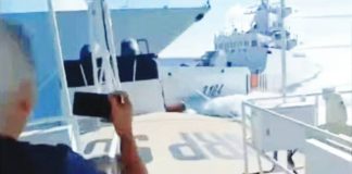 This screengrab from the Philippine Coast Guard’s video handout shows a China Coast Guard vessel colliding with a Chinese Navy warship off Scarborough (Panatag) Shoal on Monday.