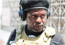 Hatian gang leader Jimmy “Barbecue” Cherizier wears a black hat and body armor. REUTERS
