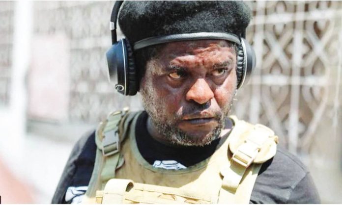 Hatian gang leader Jimmy “Barbecue” Cherizier wears a black hat and body armor. REUTERS