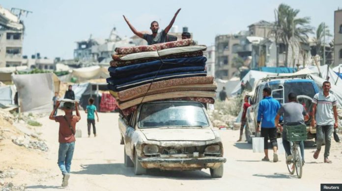 Hamas A displaced Palestinian man fleeing northern Gaza gestures atop a vehicle loaded with belongings while he heads south. Thousands of Palestinians have been fleeing from intensifying Israeli strikes in parts of Gaza City in recent days. REUTERS