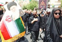 UK, France and Germany move to reimpose UN sanctions on Iran Iranians march with the Iranian flag and a picture of Iranian Supreme Leader Ayatollah Khamenei. EPA