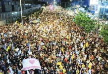 An aerial image shows a crowd of protesters filling a street, some waving yellow banners and displaying a white flag with a pink heart, calling for the release of Israeli hostages in Tel Aviv, Israel. EPA