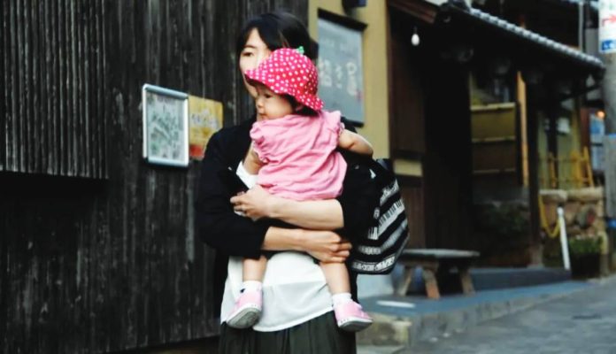 In 2024, Japan recorded 686,061 births - the lowest number since records began in 1899 - while nearly 1.6 million people died, meaning for every baby born, more than two people died. Photo shows a woman and baby in the hot spring town of Arima Onsen on the outskirts of Kobe, Japan. GETTY IMAGES