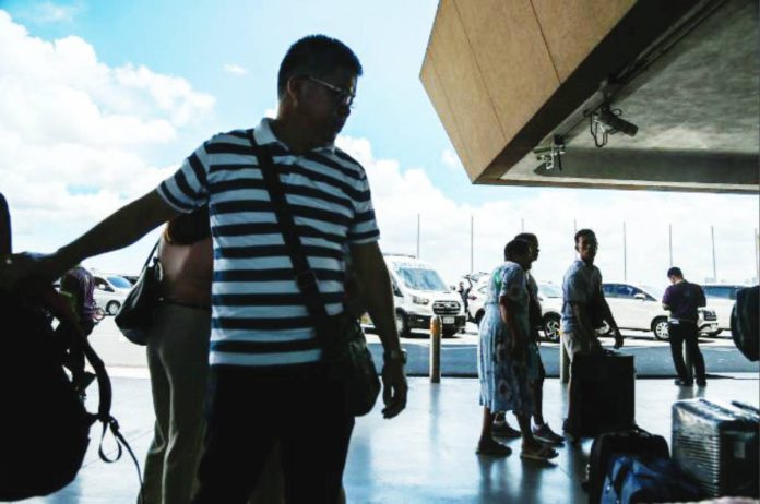 Passengers arrive at the Ninoy Aquino International Airport (NAIA) Terminal on May 5, 2025. Last July, several groups called for the cancellation of the privatization contract of the NAIA with San Miguel Corporation, saying the deal was pushing up airport fees. JONATHAN CELLONA/ABS-CBN NEWS PHOTO