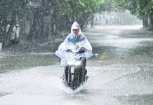 Thousands evacuate as typhoon batters Vietnam A motorbike rider wades through a partly flooded street during heavy rains in Vietnam. GETTY IMAGES
