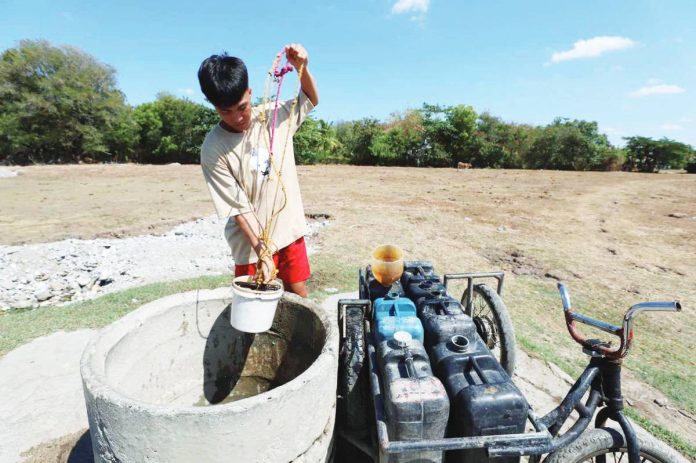 People in Iloilo City barangays are forced to extract water from shallow wells often contaminated by nearby septic systems, according to a city councilor. Photo shows a boy fetching water from a well in Barangay Navais, Mandurriao district. ARNOLD ALMACEN/ILOILO CITY MAYOR'S OFFICE FILE PHOTO