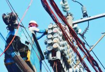Workers inspect an electric meter installed above ground in Manila on January 11, 2024. MARK DEMAYO/ABS-CBN NEWS PHOTO