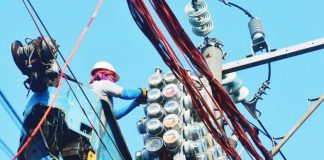 Workers inspect an electric meter installed above ground in Manila on January 11, 2024. MARK DEMAYO/ABS-CBN NEWS PHOTO