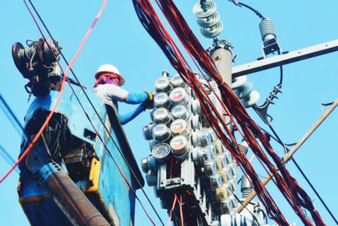 lower power rates Workers inspect an electric meter installed above ground in Manila on January 11, 2024. MARK DEMAYO/ABS-CBN NEWS PHOTO