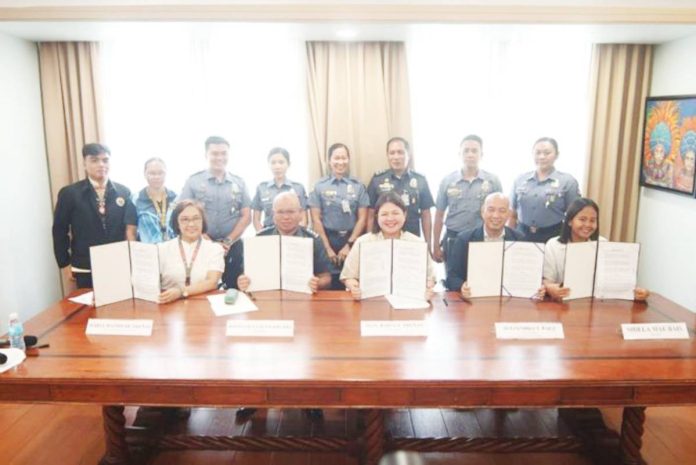Mayor Raisa Treñas (center, seated) leads the signing of a Memorandum of Agreement with the Bureau of Jail Management and Penology, Technical Institute of Iloilo City, and Philippine Foremost Milling Corporation for the continued implementation of the Jail Pantry Training Program, aimed at equipping persons deprived of liberty with livelihood skills in cooking and baking. MAYOR RAISA TREÑAS FACEBOOK PAGE