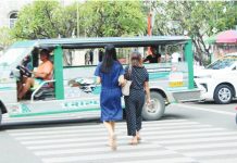 A mother and her daughter cross a pedestrian lane in Jaro, Iloilo City where advocates are calling for stronger human immunodeficiency virus awareness efforts that include not just the youth but also parents, whose beliefs can shape access to life-saving education and prevention tools. AJ PALCULLO/PN