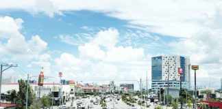 Traffic flows along Sen. Benigno Aquino Jr. Avenue in Iloilo City’s Mandurriao district, a bustling hub that continues to attract new businesses as the city posts steady growth in business permits and tax collections. MA. THERESA LADIAO/PN